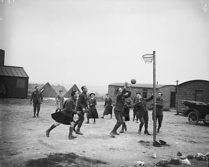 Women's Auxiliary Army Corps: WAACs and convalescent soldiers playing basketball in the camp at Etaples.