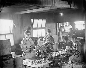 Five QMAAC [Queen Mary's Army Auxiliary Corps] cleaning silver for No. 1 Wing Officers Mess at Harfleur.