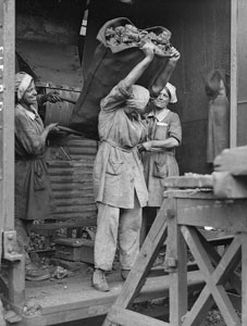 Women Gas workers carrying 1 cwt. sack of coke, South Metropolitan Gas Co., 709, Old Kent Road, June 1918