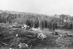 Air raid damage done at the St John's Ambulance Brigade Hospital at Etaples, May 1918. Among those inspecting the damage are some Salvation Army female workers.